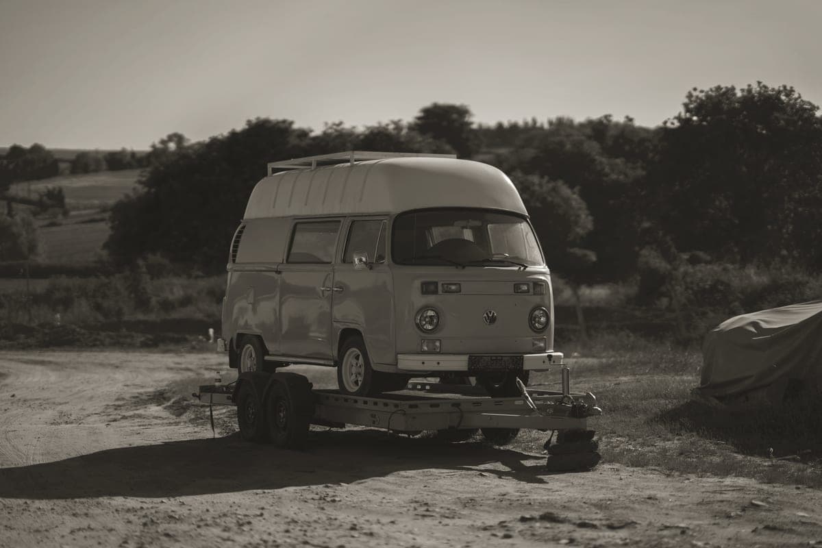 A camper trailer parked in open country at dusk